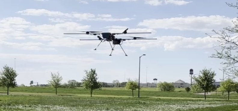 AeroFly heavy-lift multirotor in flight over a field