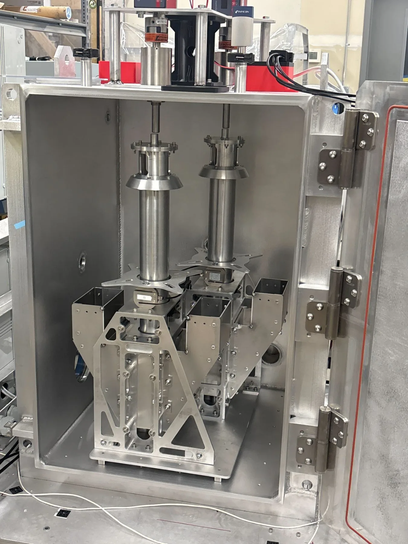 AeroFly high-vacuum chamber interior showing rotary feedthroughs and a Rego-LIFT test fixture